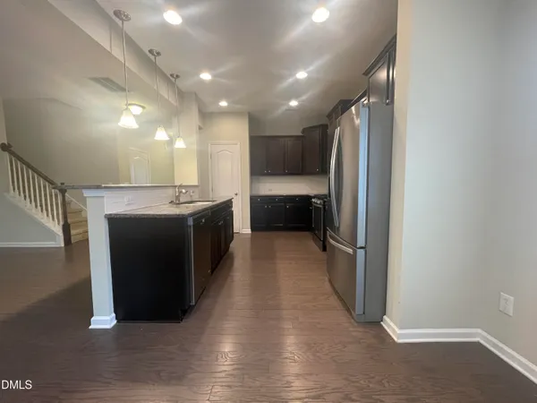 a kitchen with stainless steel appliances granite countertop a stove and a refrigerator