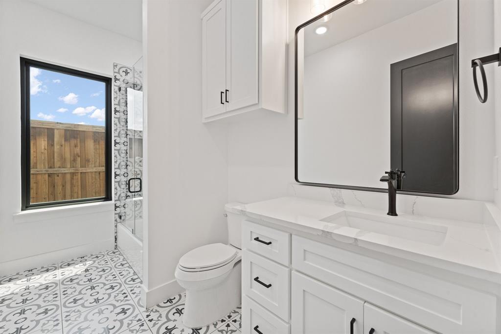 613 Wildcat Way Kennedale, TX 76060 - Photo 16 of 40 a bathroom with a sink a toilet and shower