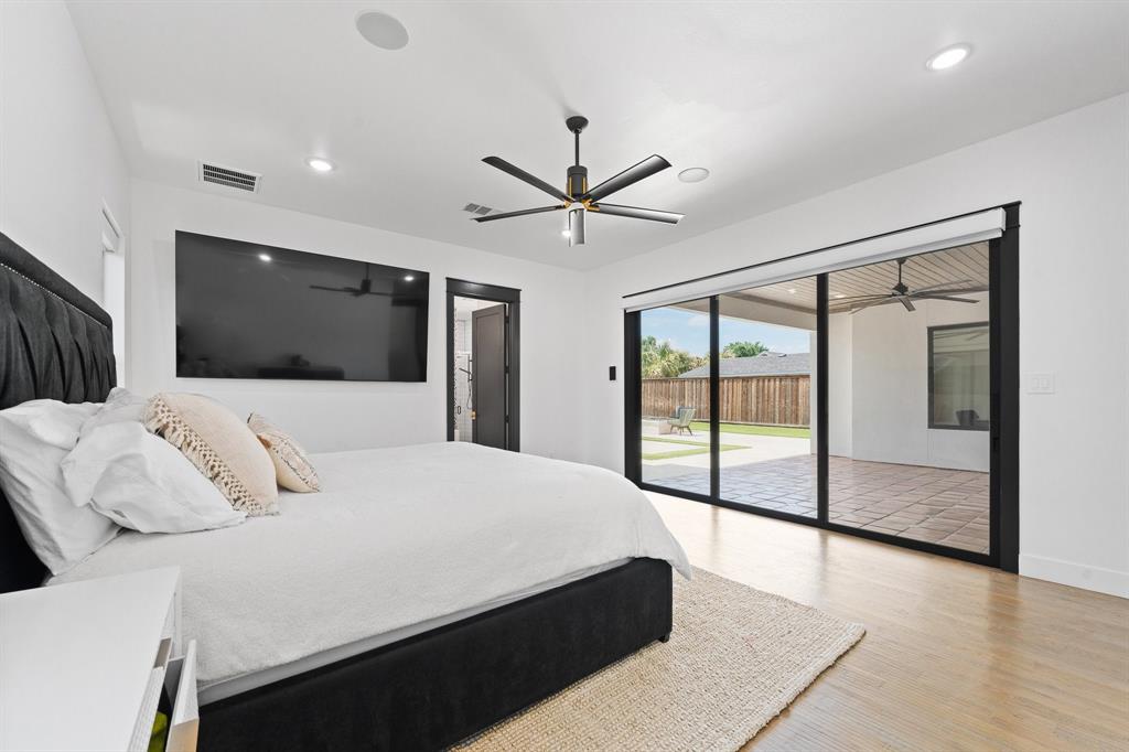 613 Wildcat Way Kennedale, TX 76060 - Photo 18 of 40 a bedroom with a large bed and a large window
