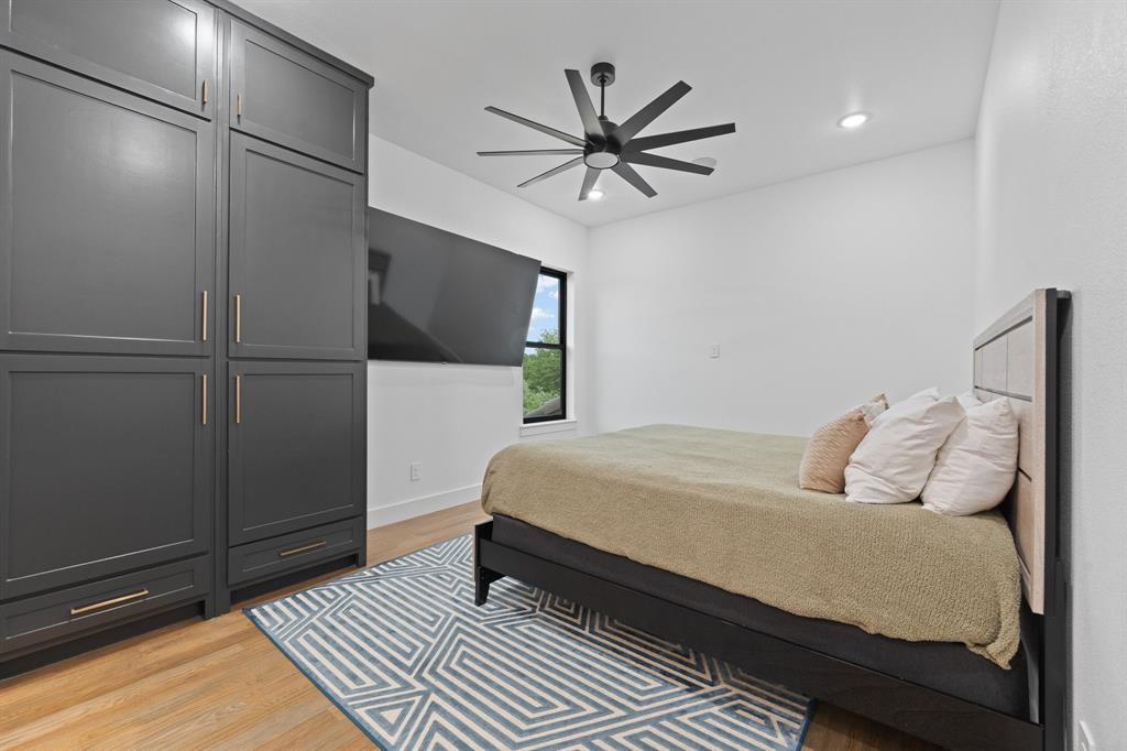613 Wildcat Way Kennedale, TX 76060 - Photo 24 of 40 a bedroom with a large bed and a chandelier