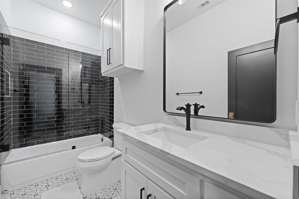 613 Wildcat Way Kennedale, TX 76060 - Photo 25 of 40 a bathroom with a sink a toilet and shower