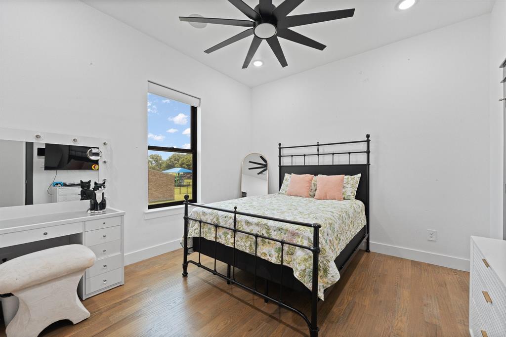 613 Wildcat Way Kennedale, TX 76060 - Photo 30 of 40 a bedroom with a bed and a chandelier