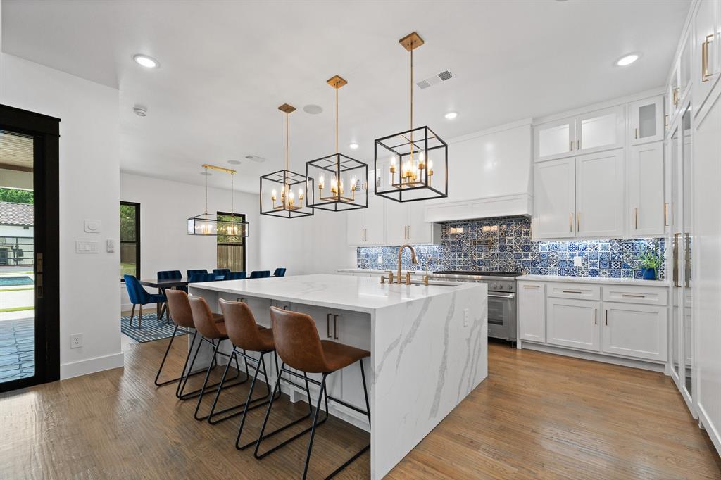 613 Wildcat Way Kennedale, TX 76060 - Photo 5 of 40 a kitchen with a table chairs stainless steel appliances and cabinets