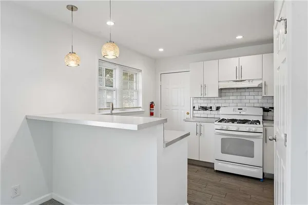 a kitchen with appliances cabinets and a sink