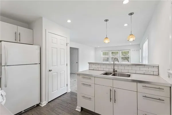 a kitchen with cabinets and window