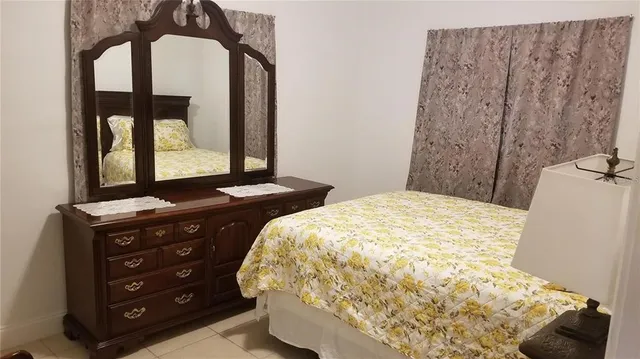 a bedroom with a bed and a mirror