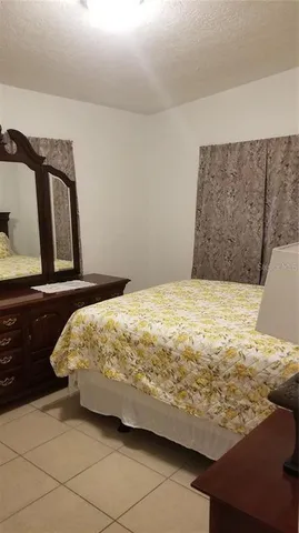 a bedroom with a bed and dresser