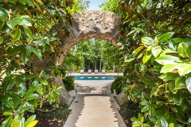 a view of a house with swimming pool and sitting area