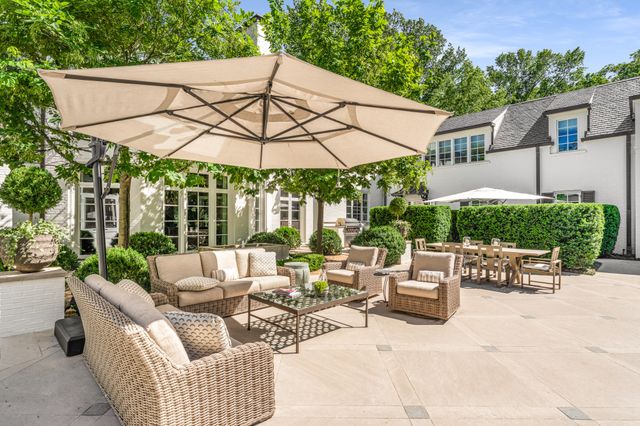 a view of a house with backyard swimming pool and sitting area