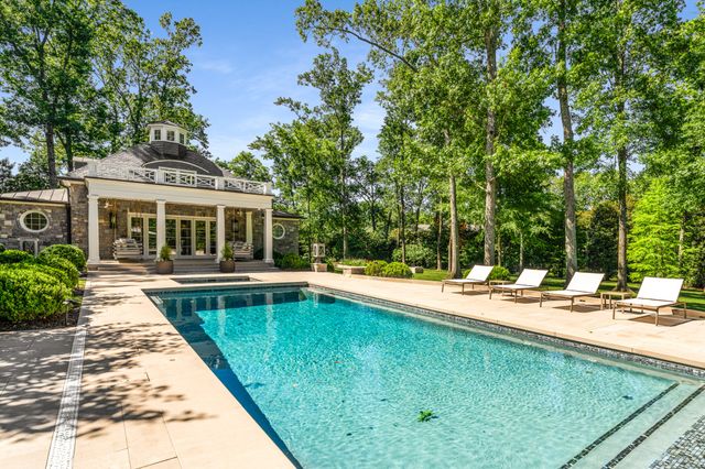 a view of a house with sitting area and garden