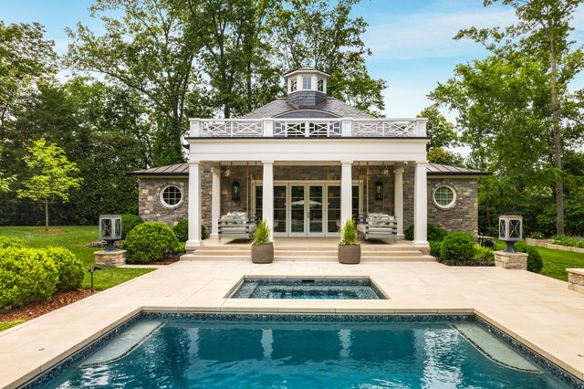 a view of a grassy field with trees in the background