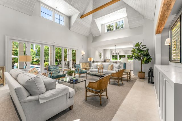 a view of a house with a yard and sitting area