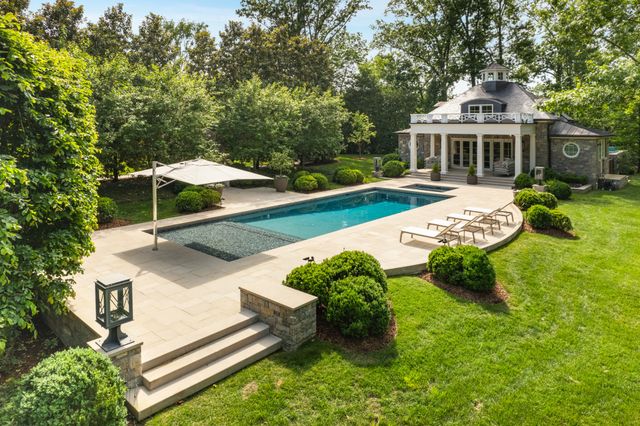a spacious bathroom with a granite countertop sink and a mirror
