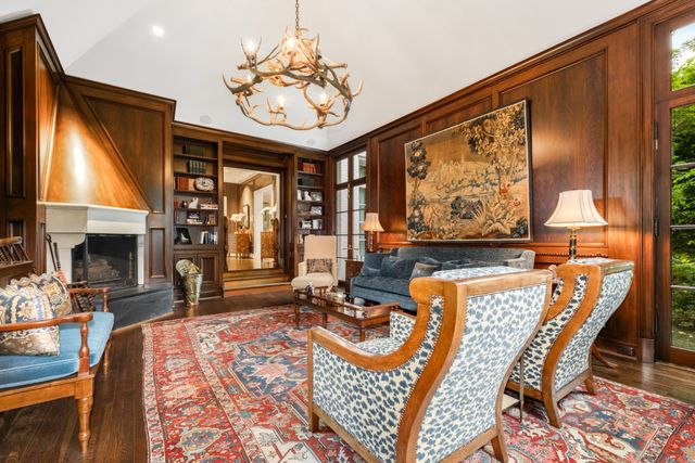 a living room with stainless steel appliances kitchen island granite countertop a stove and cabinets