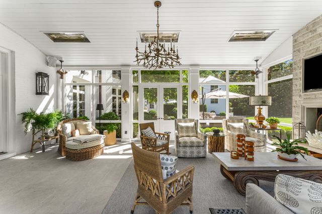 a view of a patio with a table and chairs and potted plants