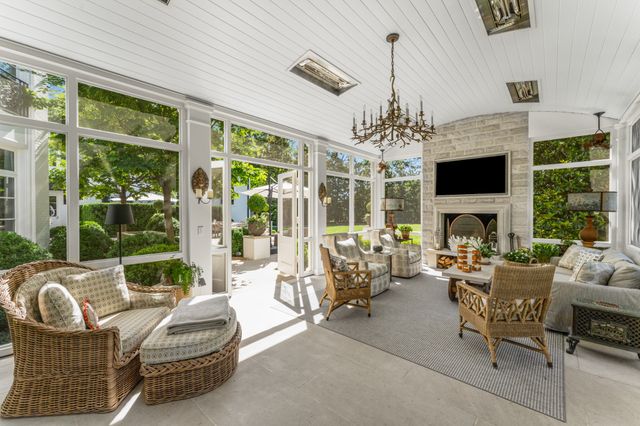 a view of a patio with a table and chairs under an umbrella