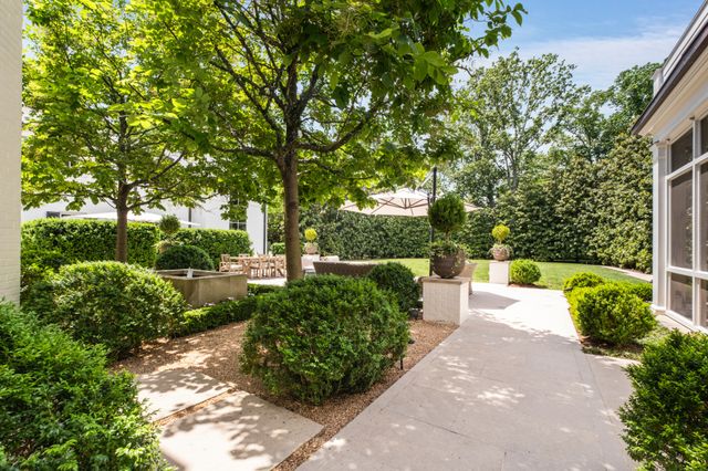 an aerial view of a house with garden space and street view
