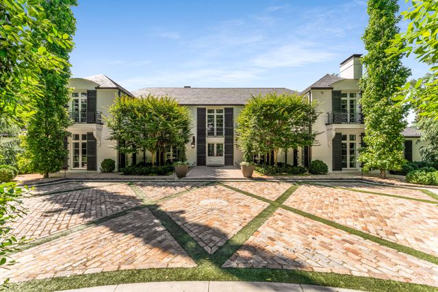 a view of a house with a yard and a street view
