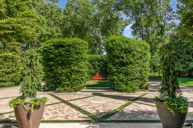 a front view of a house with a tree