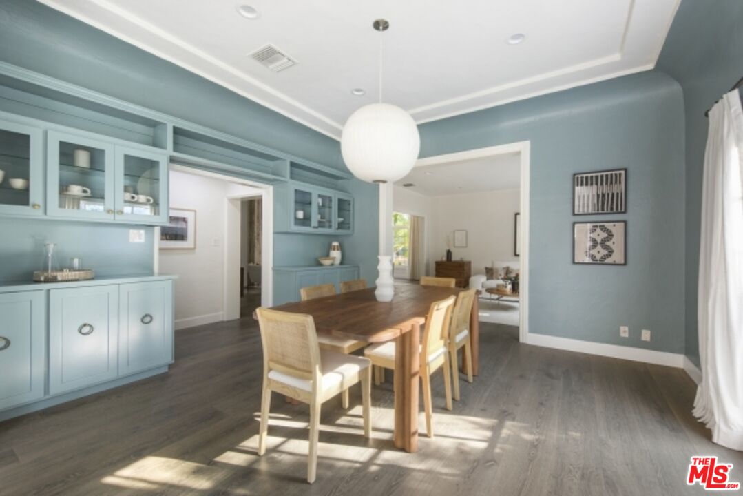 6607 Moore Drive Los Angeles, CA 90048 - Photo 12 of 42 a view of a dining room with furniture and wooden floor