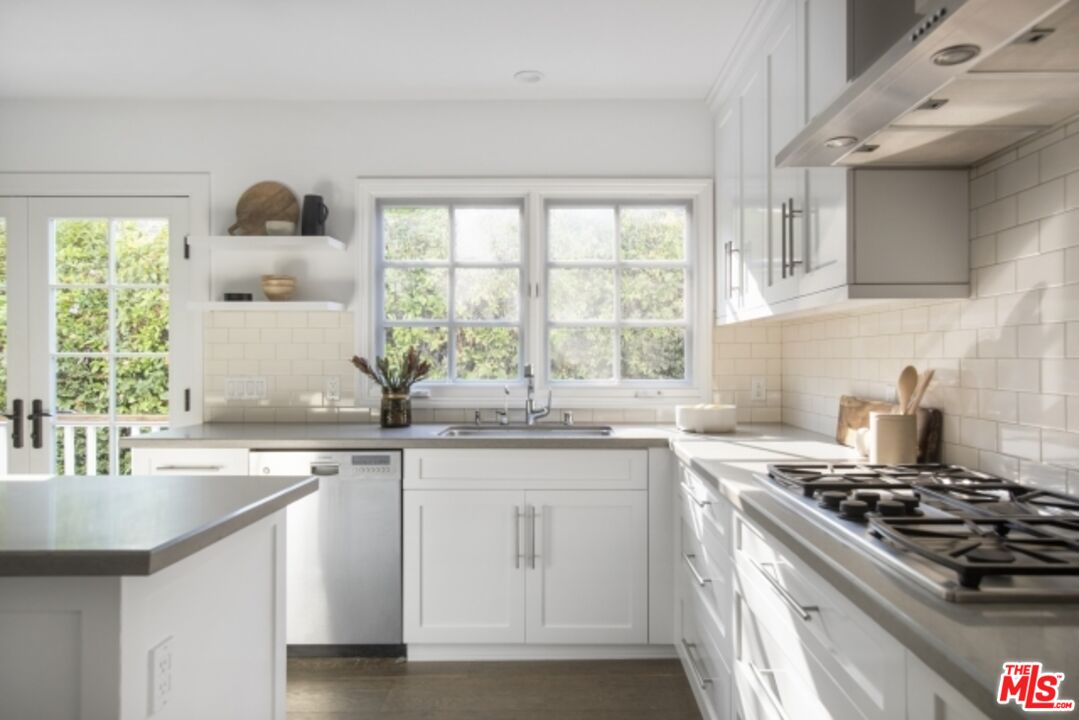 6607 Moore Drive Los Angeles, CA 90048 - Photo 15 of 42 a kitchen with stainless steel appliances a sink stove and cabinets
