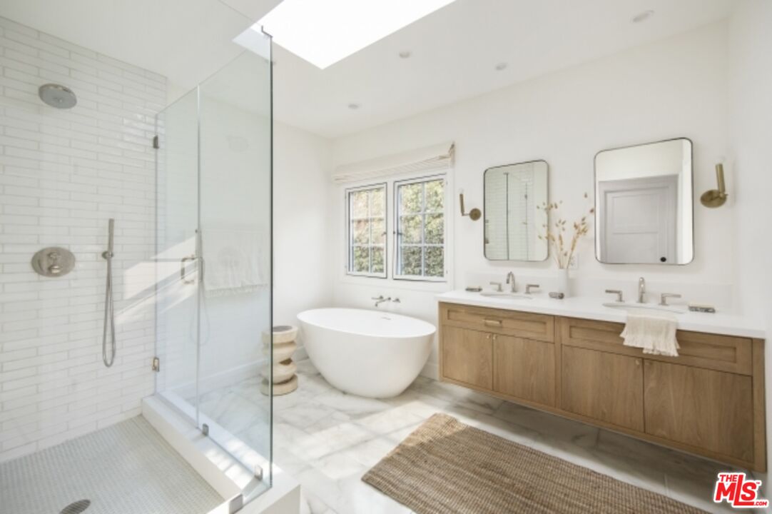 6607 Moore Drive Los Angeles, CA 90048 - Photo 19 of 42 a spacious bathroom with a tub sink mirror and a shower