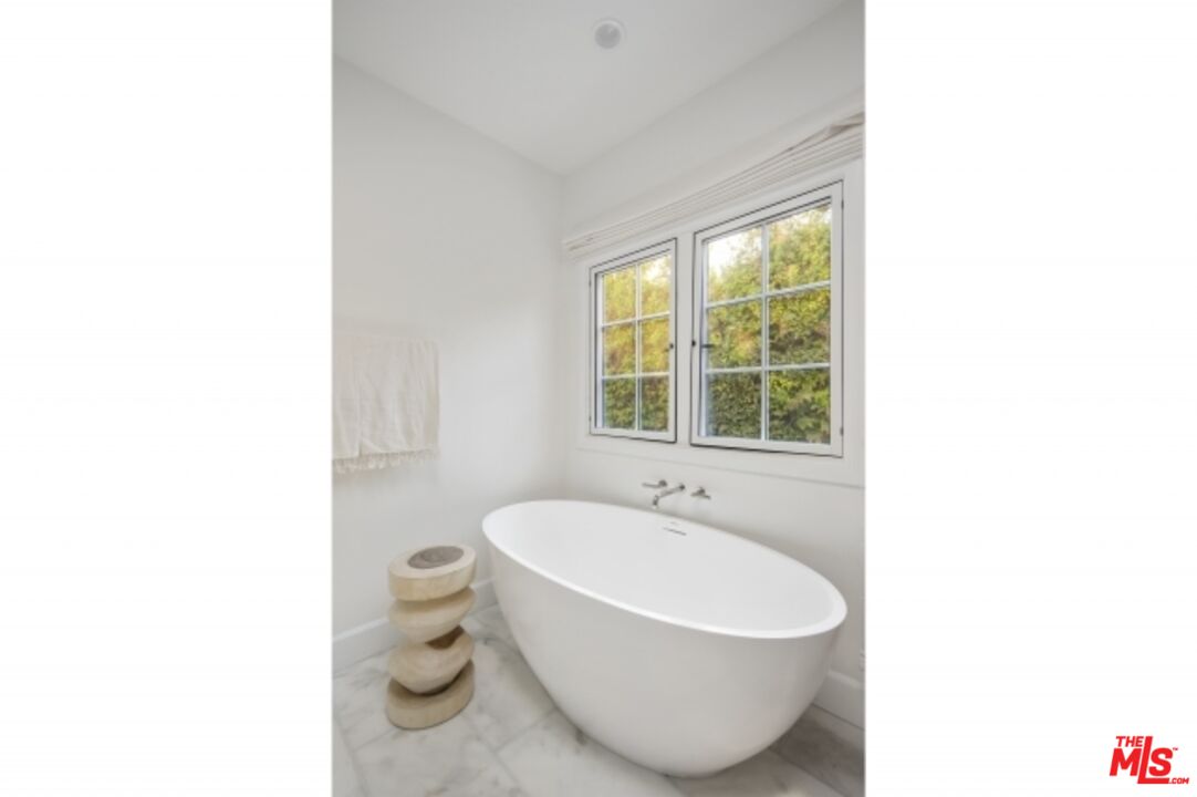 6607 Moore Drive Los Angeles, CA 90048 - Photo 21 of 42 a white bath tub sitting next to a white toilet