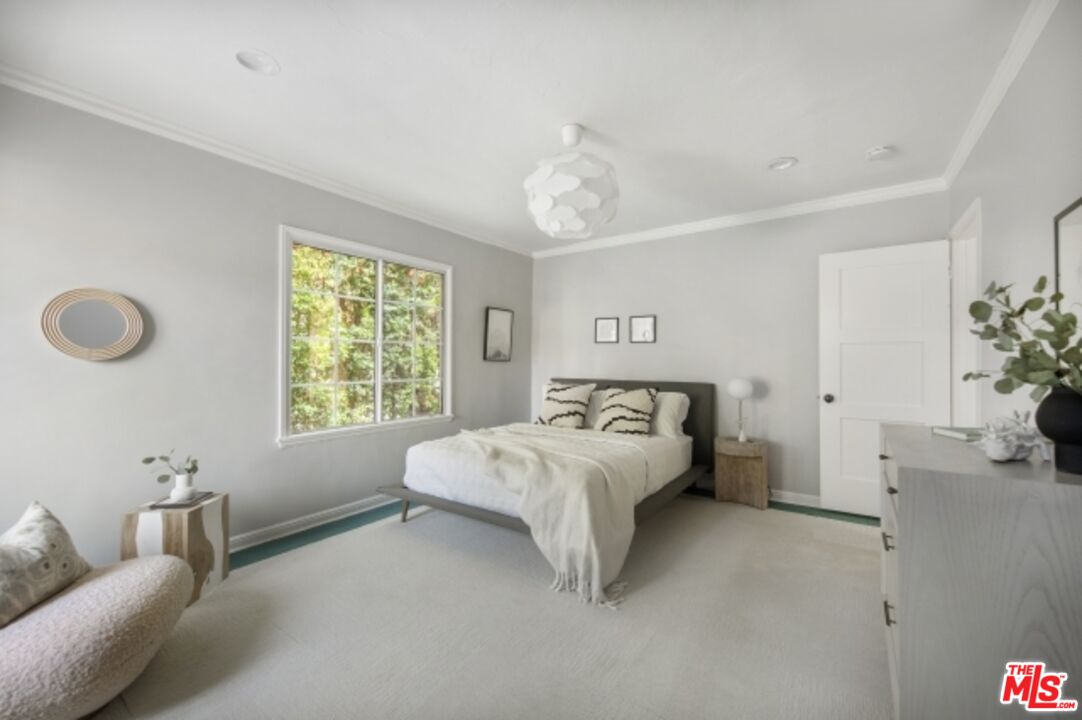 6607 Moore Drive Los Angeles, CA 90048 - Photo 22 of 42 a spacious bedroom with a bed and a chandelier