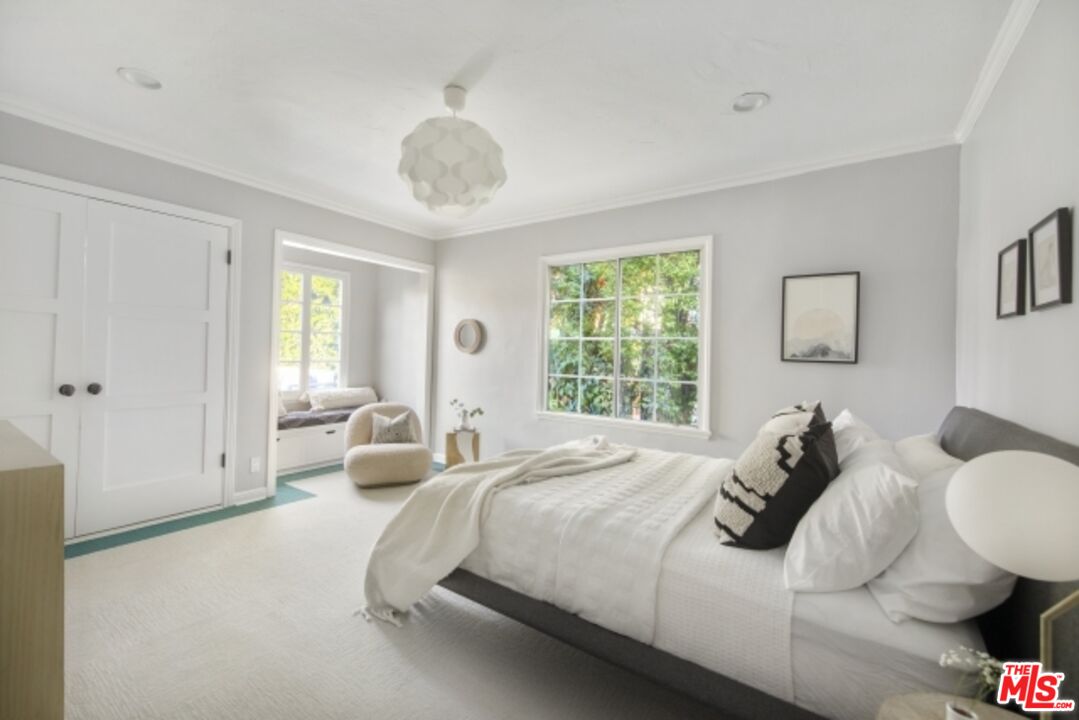 6607 Moore Drive Los Angeles, CA 90048 - Photo 23 of 42 a bedroom with bed and a large window