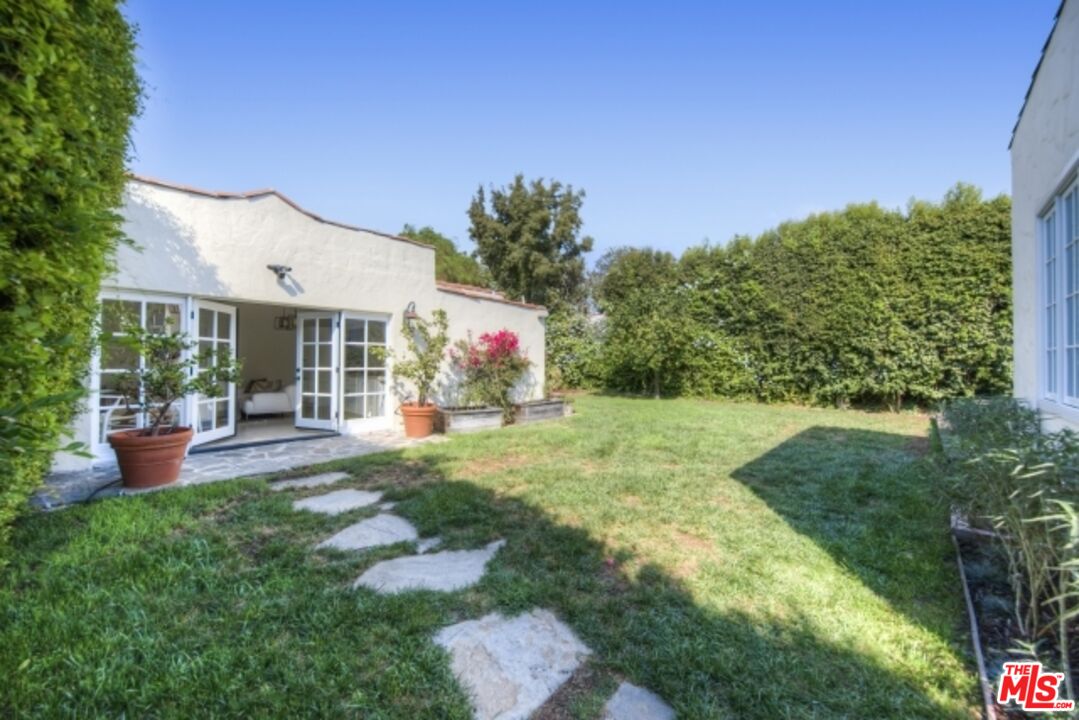 6607 Moore Drive Los Angeles, CA 90048 - Photo 29 of 42 a front view of a house with garden