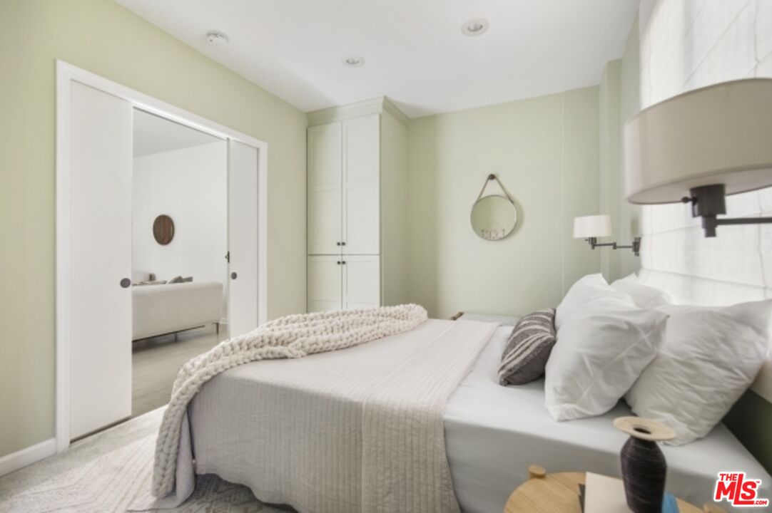 6607 Moore Drive Los Angeles, CA 90048 - Photo 35 of 42 a bedroom with a bed and cabinets