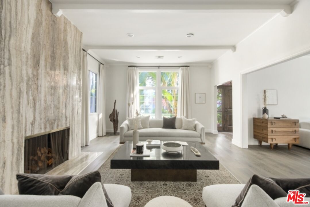 6607 Moore Drive Los Angeles, CA 90048 - Photo 6 of 42 a living room with furniture fireplace and a large window