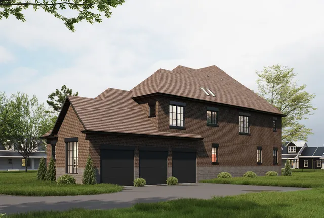 a front view of a house with a garden and yard