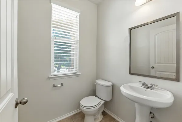 a bathroom with a sink toilet and a mirror