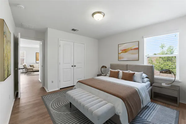 a bedroom with a bed and a couch