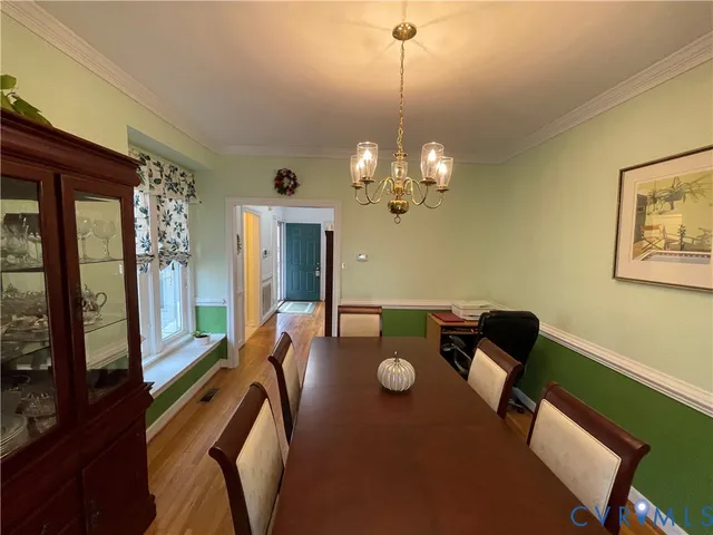 a view of a dining room with furniture and window
