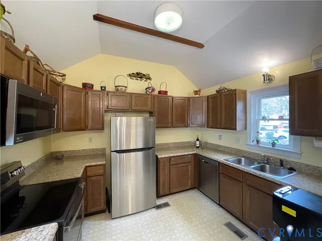 a kitchen with a sink stainless steel appliances and cabinets