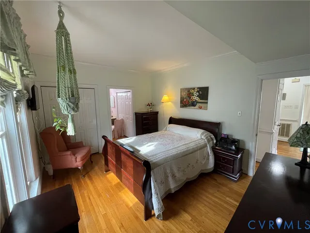 a bedroom with a bed window and a couch