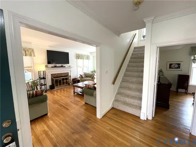 a view of a livingroom with wooden floor and furniture