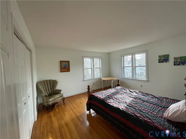 a bedroom with a bed and a chair