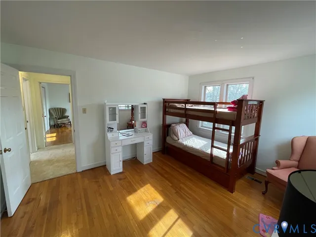 a bedroom with furniture and wooden floor