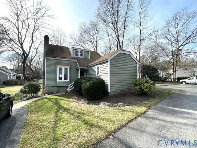 a view of a house with a yard covered in snow