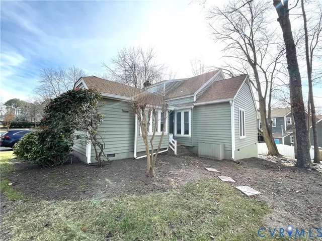 a view of a house with a yard and sitting area