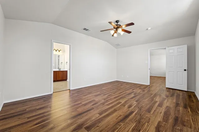 a view of room with wooden floor and ceiling fan