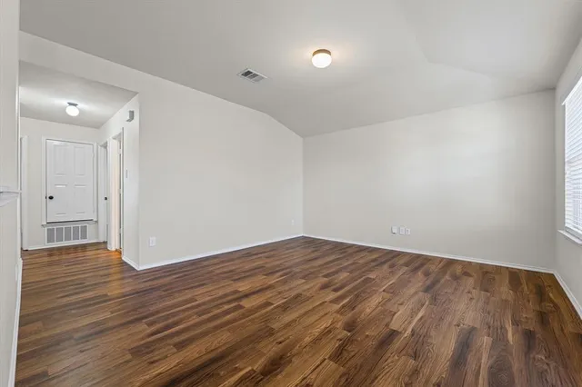 a view of entryway with white walls and open door