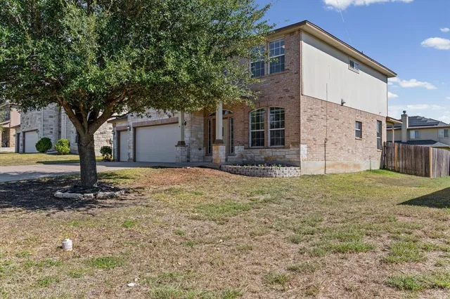 a front view of house with a garden