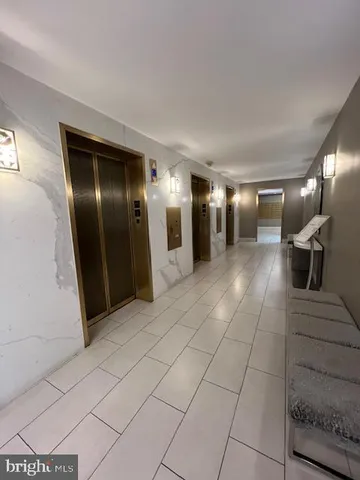 a view of a hallway with seating area