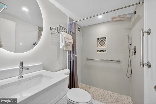 a bathroom with a sink toilet and shower