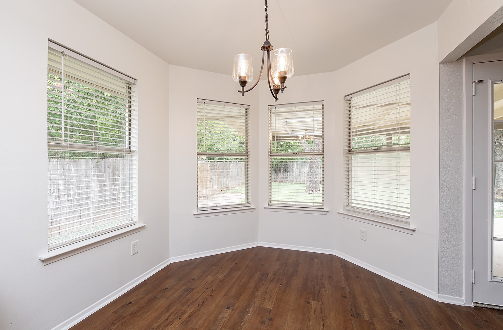 910 Garden View Drive Georgetown, TX 78628 - Photo 13 of 33 a view of an empty room with wooden floor and a window