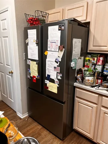 a kitchen with stainless steel appliances granite countertop a refrigerator and a stove
